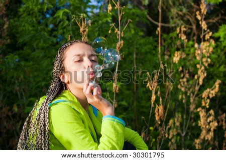 beauty girl belly soap bubbles on nature background