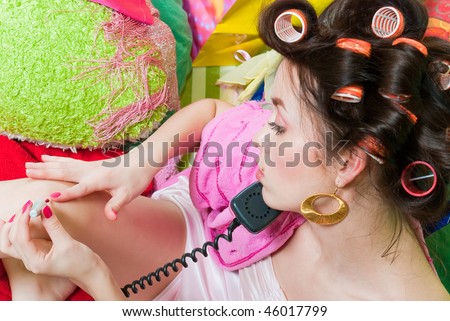 beauty girl pink phone call and paint her nails on color background