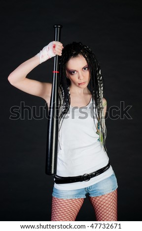 beauty wounded girl with bat isolated on black background