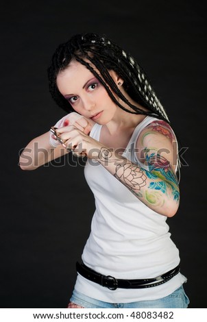 beauty girl with knuckleduster and with body art on her hand