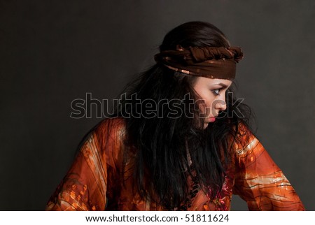 beauty young Gypsy woman on the gray background
