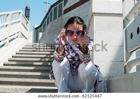 beauty girl sit on stairs  on the wall and stairway background