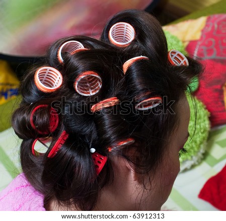 woman hair rollers on the color background