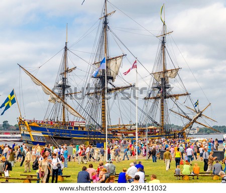 RIGA, LATVIA - JULY 27, 2013: Sweden sailing frigate at port of Riga during regatta and many people around it.