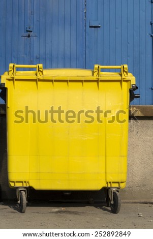 Yellow garbage bin