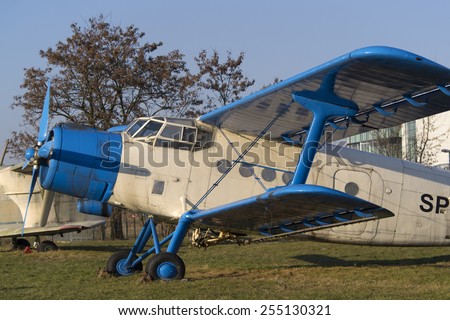 Light blue and white biplane aircraft in museum