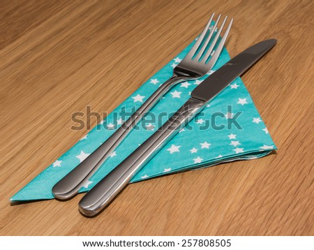 Napkin with fork and knife served on table