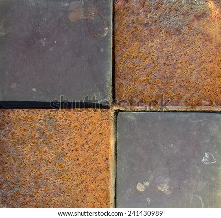 Closeup area of terracotta tiles rusty iron background.