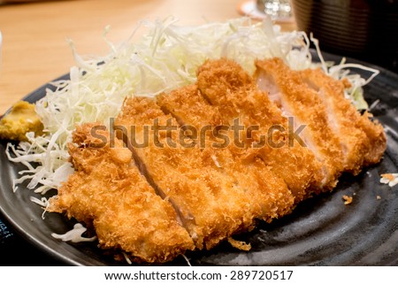 Tonkatsu serve with slice cabbage.
Deep Fires pork loin.
Most favorites Japanese food. 
made by pork lion with bread crumb. deep fry to golden brown colour