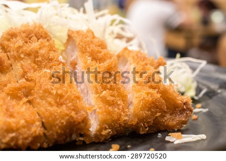 Tonkatsu serve with slice cabbage.\
Deep Fires pork loin.\
Most favorites Japanese food. \
made by pork lion with bread crumb. deep fry to golden brown colour