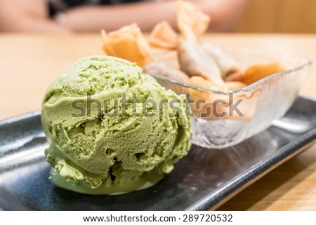 Japanese Green tea ice cream \
serve with deep fired Red bean toffy\
focus on green tea ice cream