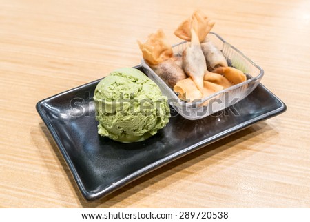 Japanese Green tea ice cream 
serve with deep fired Red bean toffy
focus on green tea ice cream