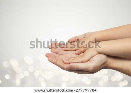father and son holding hands on beautiful christmas lights background