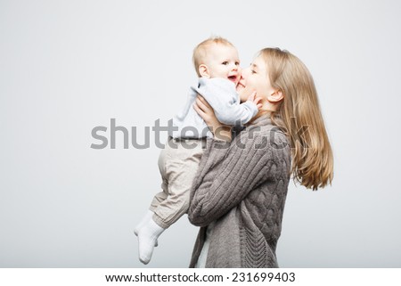 Mother playing with baby girl, happy family having fun indoor, mom and child isolated on white background.