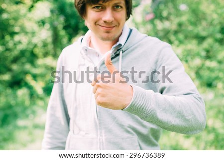 young man with his finger thumb up. Ok by hand