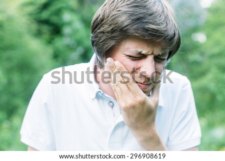 Young man having a tooth pain