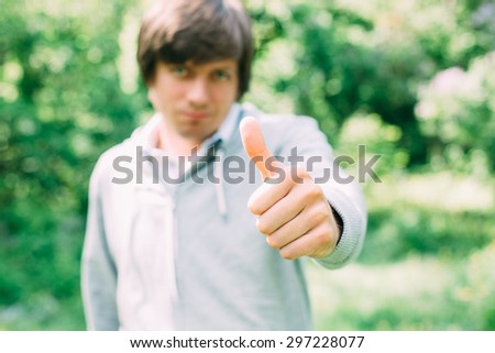 young man with his finger thumb up. Ok by hand