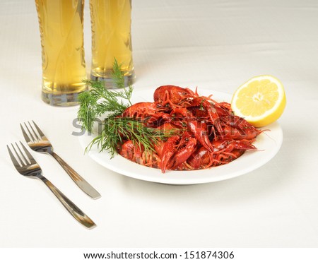 Plate full of river lobsters with beer and lemon