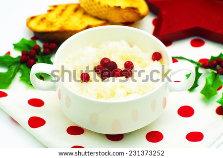 Rice porridge in the white dish with cranberries