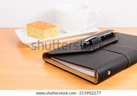 black organizer with coffee and  cake ,coffee break