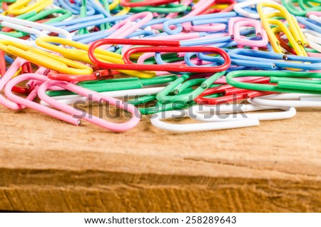 group of colorful paper clip on wooden board