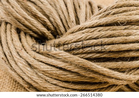 close up roll of rope on sack cloth,burlap