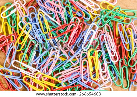 group of colorful paper clip on wooden board