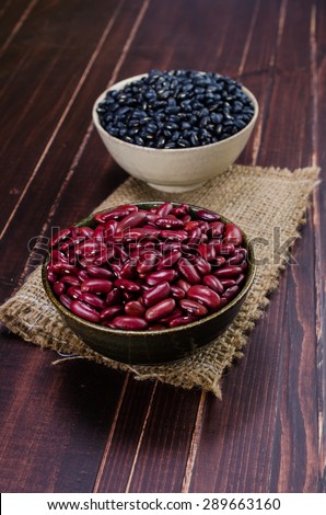 kidney bean and black bean in ceramic bowl on wooden board