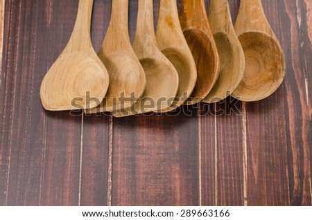 set of wooden spoon on wooden background,ladle