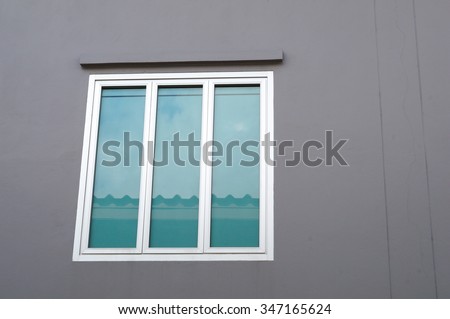 Window reflections on gray wall
