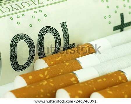 Smoking is expensive habit. Cigarettes on money background.
