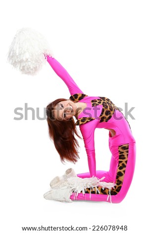 Young sports flexible cheerleader girl in the pink leo suit bends backwards. Young high school female dancer standing with pom-poms on isolated white background.