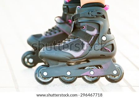 Close-up view of girl\'s legs in roller blades