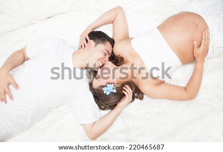 Couple lying on the back smiling and giving love to each other