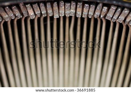 Semi-abstract view of the key strikes (key bars) inside an old fashioned typewriter, of the 1900-1920 era. Photo has been flipped horizontally in Photoshop.
