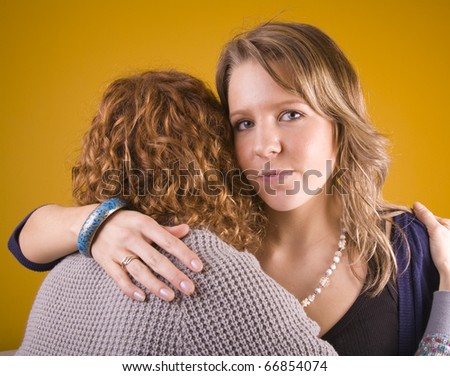 Young woman comforting a friend.