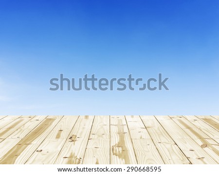 Wood table top on Clear blue sky backgrounds.