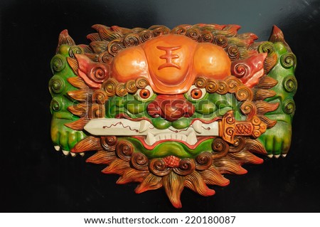 Tainam, South Taiwan - July 8, 2014 : Decoration on the door, sword lion of Temple in Anping  old Street Tainam, South Taiwan. Temple is open for public and welcome to take photos .