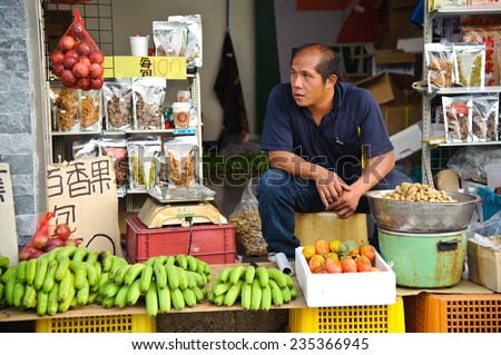 Taichung, Taiwan - Aug 8, 2014: Unidentified seller of fruits, vegetables and other snacks in Taichung. Taichung has a lot of farms and provide different kinds of vegetables and fruits.