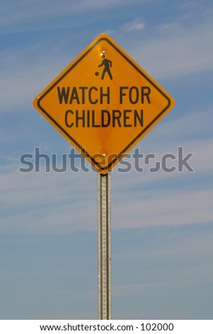 A sign states that you should watch for children.