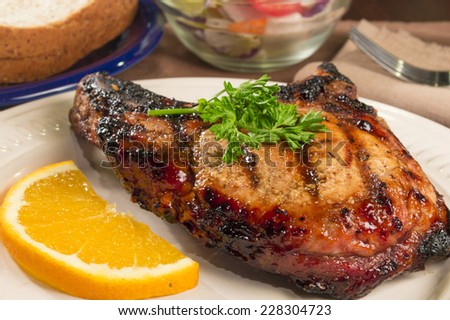 seasoned char grilled pork chop ready to enjoy \