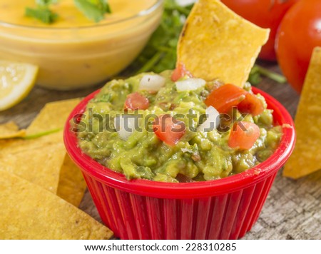 fresh homemade guacamole with hot cheese dip and tortilla chips \