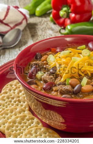 hot bowl of three bean chili with crackers \