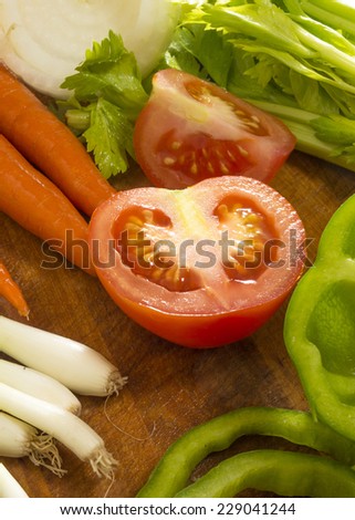 raw vegetables being cut up on a cutting board for a salad \