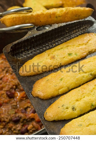 jalapeno cornbread freshly baked in a cast iron corn cob mold being served\