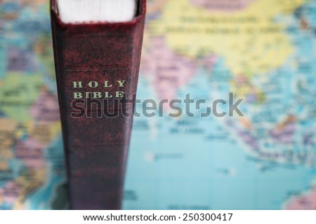 Holy Bible stand on the world map, Mission of God.