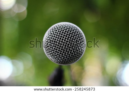 Close up of microphone in garden concert background. Macro with shallow dof.