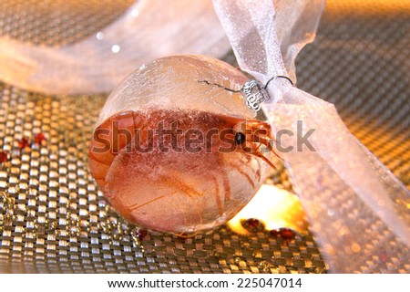 creative picture of a frozen shrimp in a Christmas ball made of frozen water