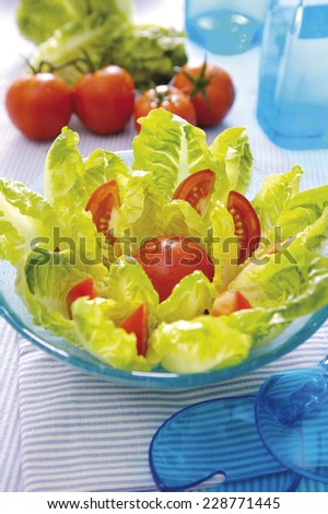 hearts of lettuce salad with tomatoes in blue atmosphere