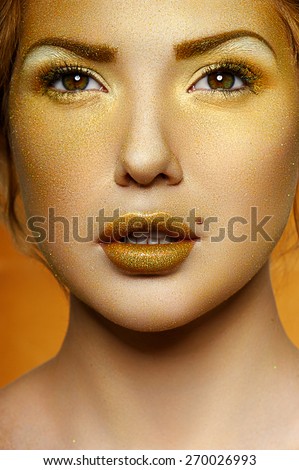 Fashion Female Model with Gold on beautiful Face